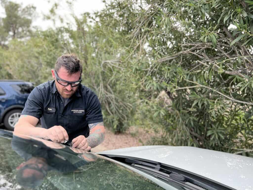 American Warrior Auto Glass performing a windshield repair